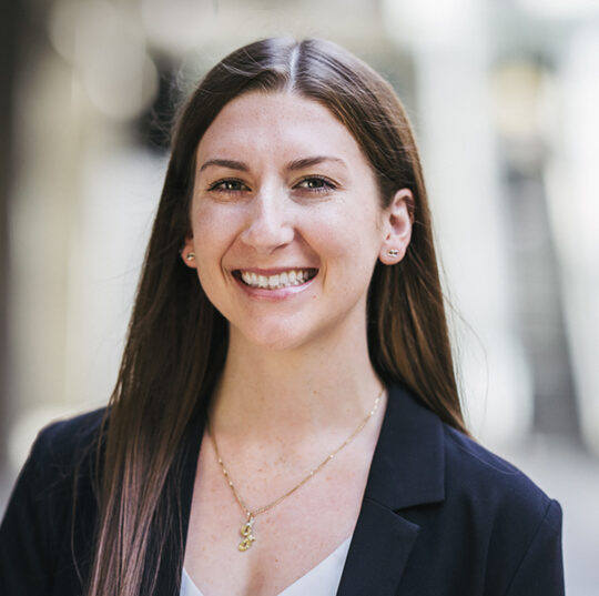 Headshot for Julia Allen. She is wearing a black blazer with a grey shirt.