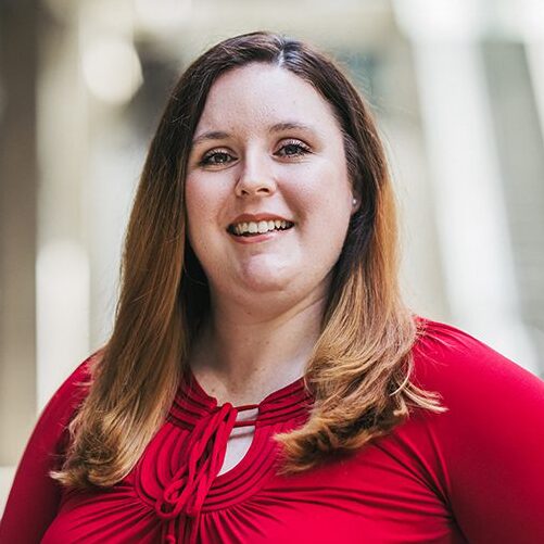 Headshot for Michelle Romero. Michelle is wearing a red shirt.