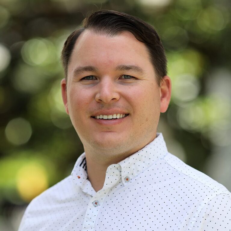 Headshot of a man wearing a white shirt