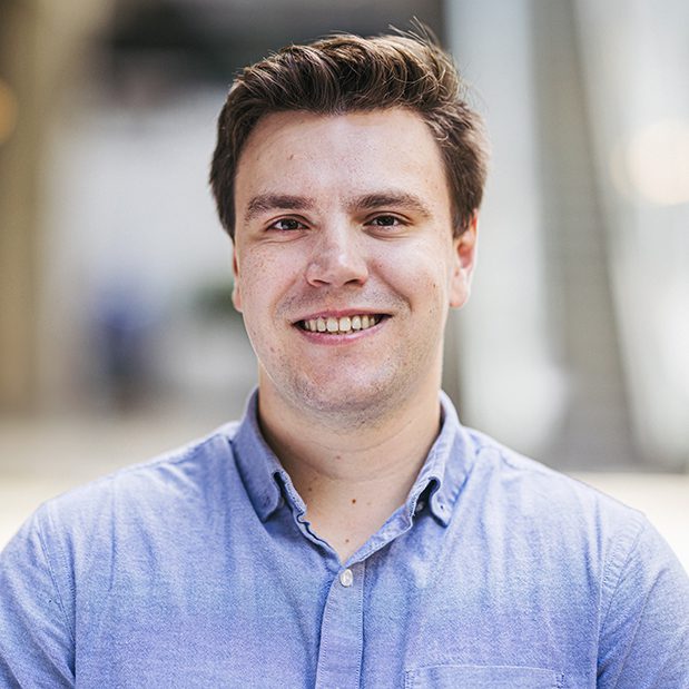 Jonathan Delgado Headshot. Jonathan is wearing a blue button up shirt.