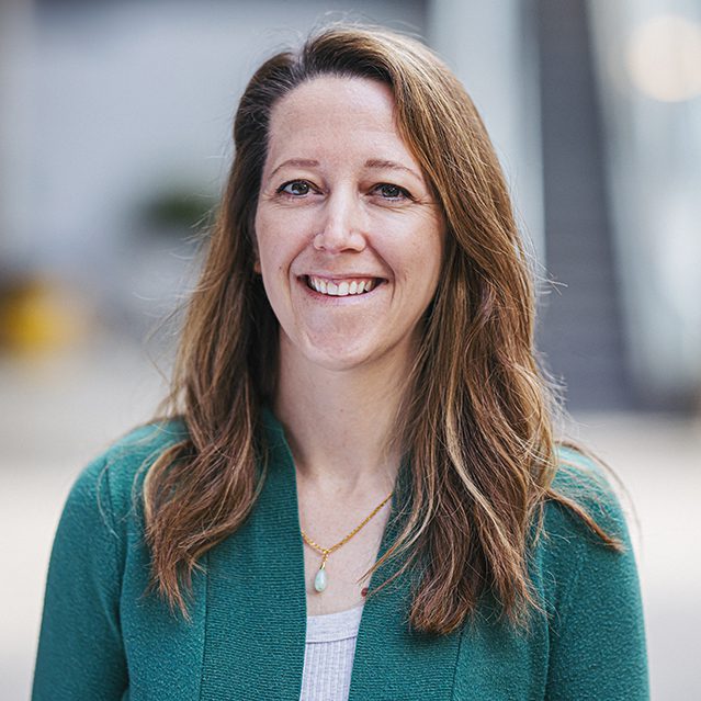 Liz Tso Professional Headshot. Liz is wearing a green jacket with a white shirt.