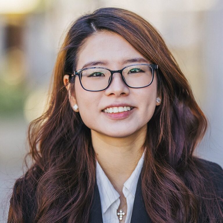 Woman in a black jacket and white shirt