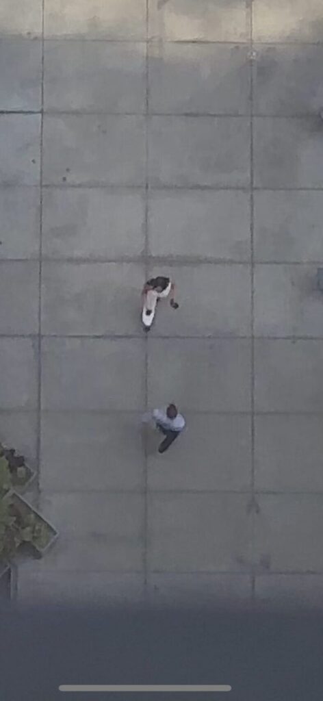 A marketing intern works with an engineer to record a social media post