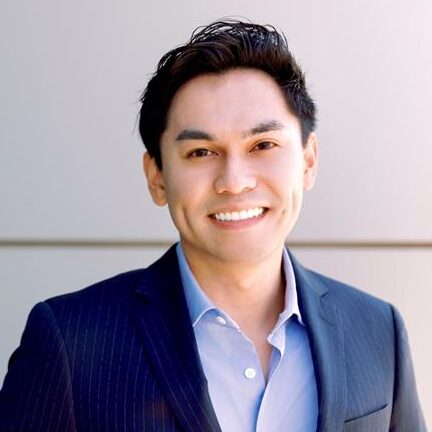 Man in light blue shirt and dark blue jacket