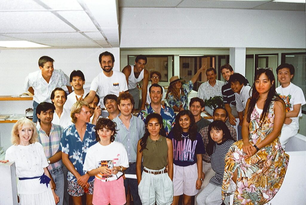 Group of employees in an office setting in the 1980s. 